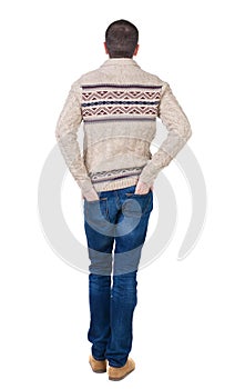 Back view of handsome man in warm sweater looking up.