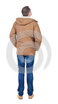 Back view of handsome man in winter jacket looking up.