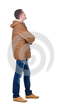 Back view of handsome man in winter parka looking