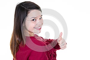 Back view of a happy woman making thumb up gesture