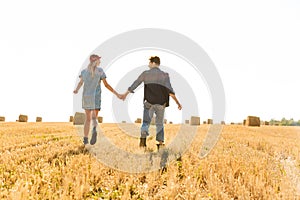 Back view of a happy young couple walking together