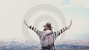 Back view happy young female tourist with arms wide open at incredible summer mountain top scenery on Vesuvius in Italy.