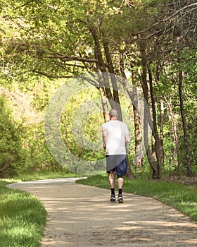 Back view of healthy man running in the park near Dallas, Texas