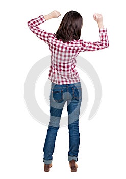 Back view of joyful woman celebrating victory hands up