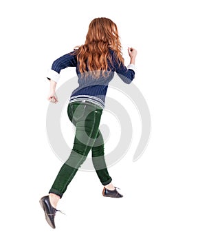 Back view of jumping woman in jeans.