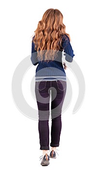 Back view of jumping woman in jeans.