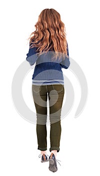 Back view of jumping woman in jeans.