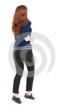 Back view of jumping woman in jeans.