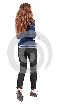 Back view of jumping woman in jeans.
