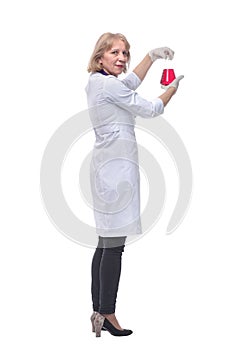 Back view of a lab scientist woman with gloves observes a beaker