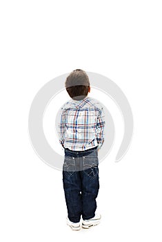 Back view of little boy looking at wall. Rear view