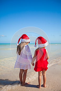 Back view of Little cute girls in Christmas hats