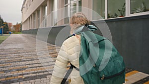 Back view little girl backpack run sidewalk city outside daughter offspring child childish schoolgirl learning hurry