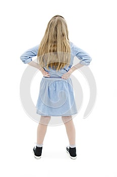 Back view of little girl looking at wall. Rear view