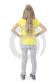 Back view of little girl looking at wall. Rear view.
