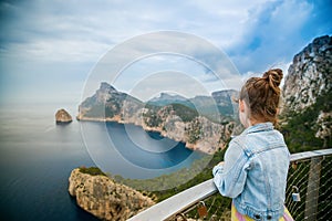 Back view of a little girl watching a beautiful view to the cape Formentor