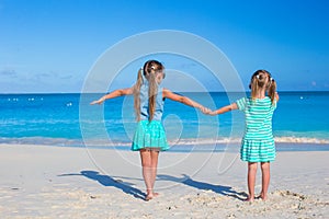 Back view of little girls enjoying summer beach