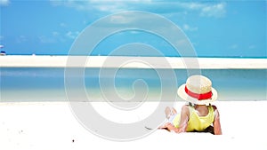 Back view of little kid in hat at the beach during caribbean tropical vacation. SLOW MOTION.