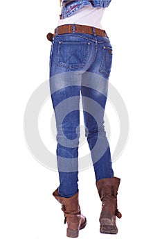 Back view of a long woman legs posing with jeans