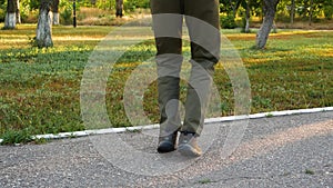 Back view of male jumping through skipping rope outside. Young energetic man doing training, promoting active lifestyle