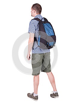 Back view of man with backpack looking up.