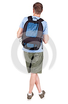 Back view of man with backpack looking up.