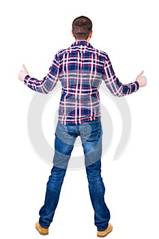 Back view of man in checkered shirt shows thumbs up.