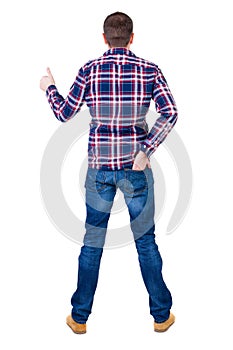 Back view of man in checkered shirt shows thumbs up.