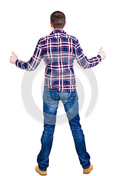 Back view of man in checkered shirt shows thumbs up.