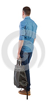 Back view of a man with a green bag