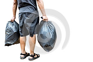 Back view,Man holding a black trash bag containing garbage in his hands,two plastic bags of rubbish for separating recycling and