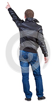 Back view of man in jacket pointing.