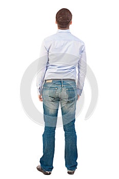 Back view of man in jeans.