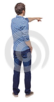 Back view of a man in jeans points his hand upwards
