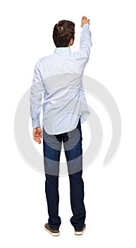 Back view of a man in jeans points his hand upwards