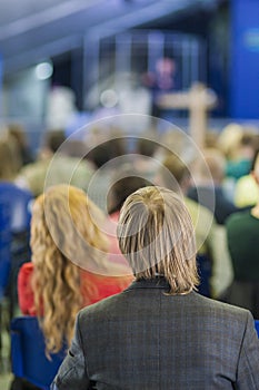 Back View of Man Listening to Professional Lecturer Speaking In front of the People.