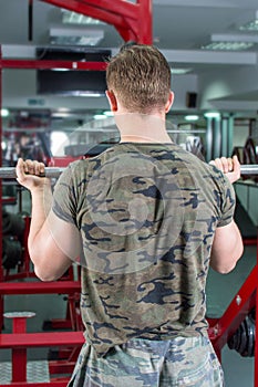 Back view of a man performing biceps workout