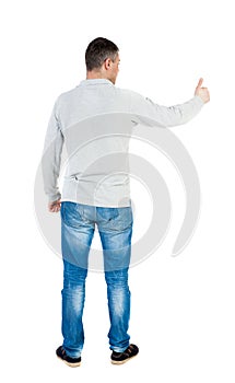 Back view of man in shirt shows thumbs up.