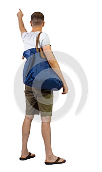 Back view of man in shorts with bag pointing