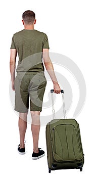 Back view of man in shorts with suitcase