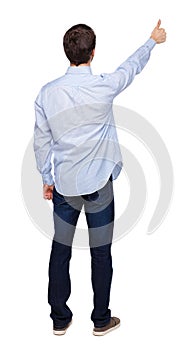 Back view of a man showing thumb up