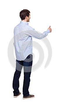 Back view of a man showing thumb up