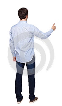 Back view of a man showing thumb up