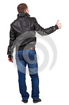 Back view of man shows thumbs up.