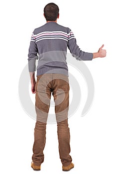 Back view of man shows thumbs up.