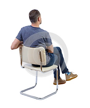 Back view of a man sitting on a chair