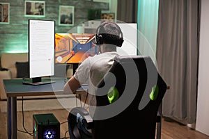 Back view of man sitting on gaming chair