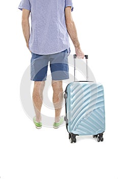 Back view of man with suitcase. Backside view of person. Guy with a travel bag on wheels