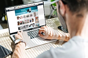 back view of man using laptop with amazon website