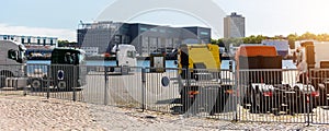 Back view many new heavy commercial cargo transport vehicles stand at port for export import shipping in Germany. Modern